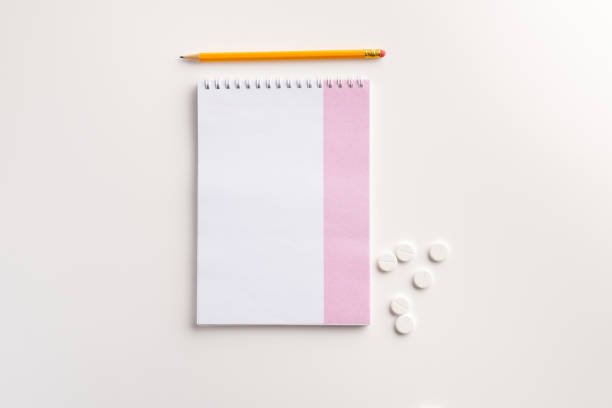 istock Notebook, pencil and  pills on white background. Flat lay. 1165500204