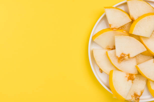 istock Sliced Yellow Musk Melon Served on Plate, Pastel Background and Copy Space 1165500252