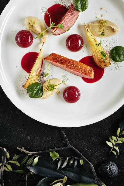 istock Exquisite Serving Creative Molecular Dish of Duck Breast, Baked Pear and Cherry Spheres Top View 1165501299