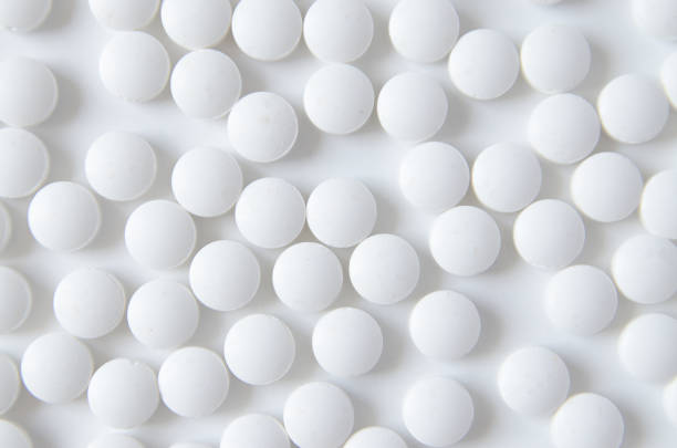istock Background of pills on white table 1165502637