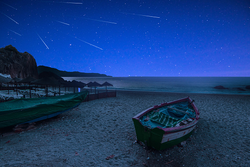 Stary Night and Perseid Meteor Shower on Beach.