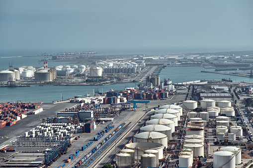 Barcelona, Spain - May, 27 2018: aerial view to Oil storage tanks and cargo containers at the port of Barcelona.