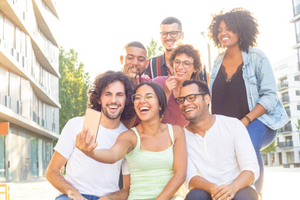 istock Positive cheerful multiethnic people taking group selfie 1165507235