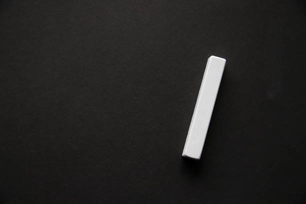istock One piece of white chalk on black coated paper 1165508550