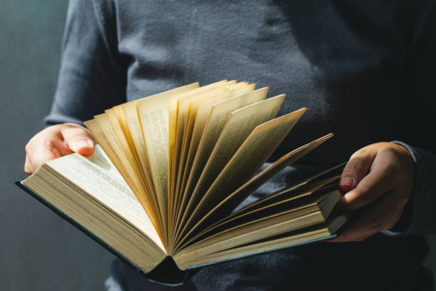 istock Education and book concept.woman holding open book 1165508744