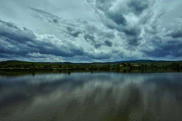 Dark sky full of clouds reflecting in the lake