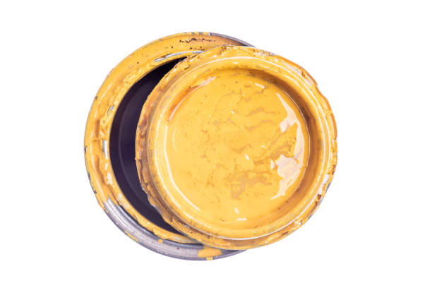 Grinding yellow oil paint with a muller on a sandblasted glass slab
