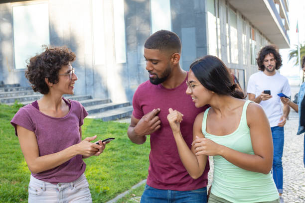 istock Team of friends chatting while walking outdoors 1165512714
