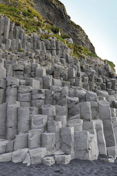 istock Reynisfjall mountain and Gardar basalt cliffs - hexagonal-shaped basalt columns on the Reynisfjara black sand beach on the south coast of Iceland near the village of Vik i Myrdal. 1165514333