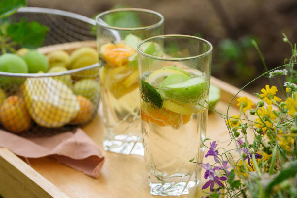 istock Summer lemonade with lemon, lime, ginger, with wildflowers on the table. Cooling drinks 1165514415