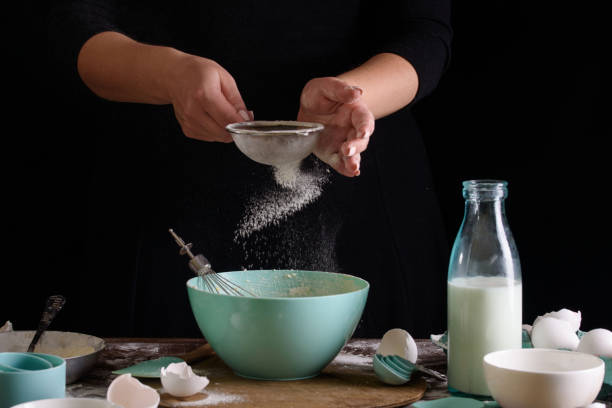 istock Cook in the kitchen. Making dough for cupcakes. Cooking process, cook hands 1165514465