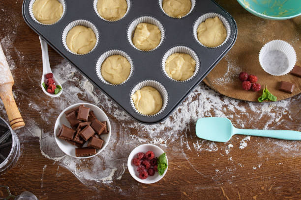 istock The process of making muffins with raspberries and chocolate. View from above. Cupcakes baking layout. 1165514475