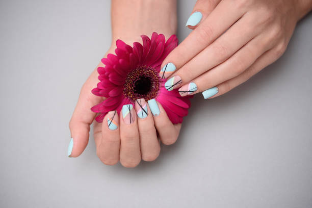 istock Beautiful delicate manicure on female hands, on pastel background. 1165515063