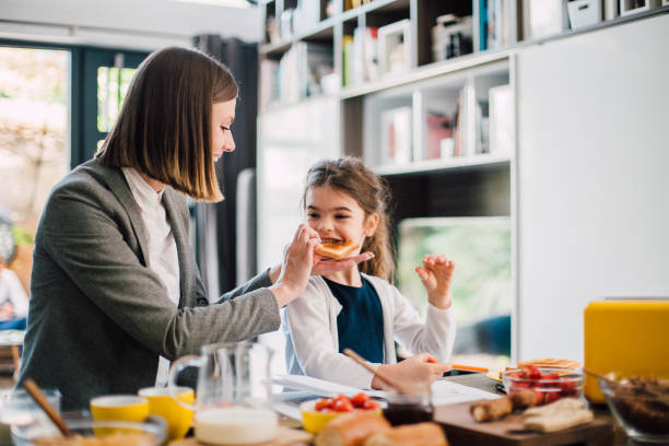 istock Mother and daughter eating breakfast 1165516425