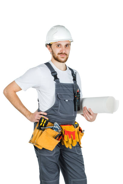 istock A builder or employee in a protective helmet with drawings in hand. Isolated on white background 1165516841