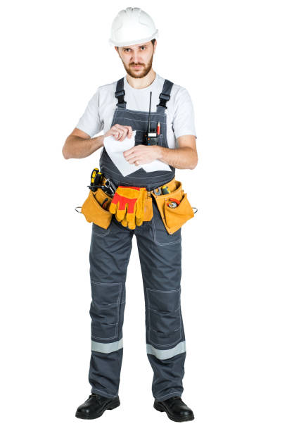 istock A builder or worker in a protective helmet breaks the contract that he holds in front of him. Isolated on white background 1165517143