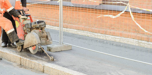 istock Road worker cutting asphalt road, working on the road reconstruction.Panorama view. 1165518339