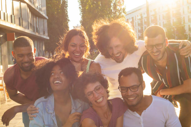 istock Positive happy mix raced friends taking group selfie 1165518554