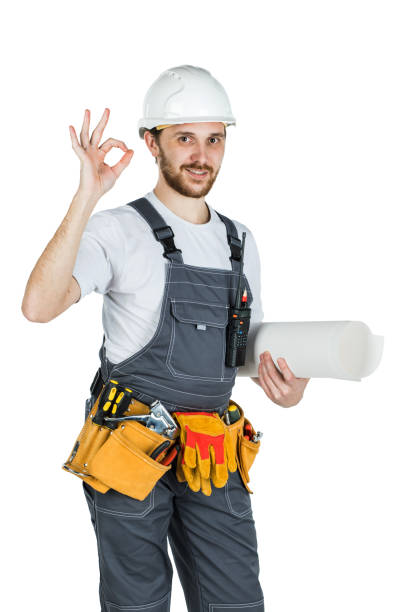 istock A builder or employee in a protective helmet with drawings in hand. Isolated on white background 1165519269