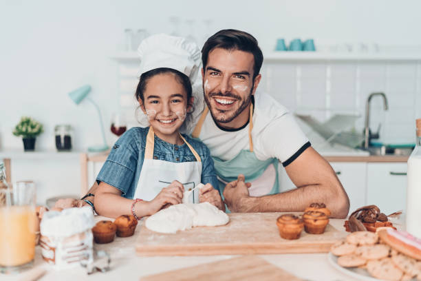 istock Happy father and daughter in the kitchen 1165519489