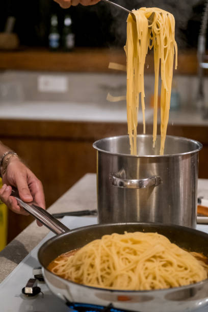 istock Spaghetti boiling in hot water on the stove 1165519648
