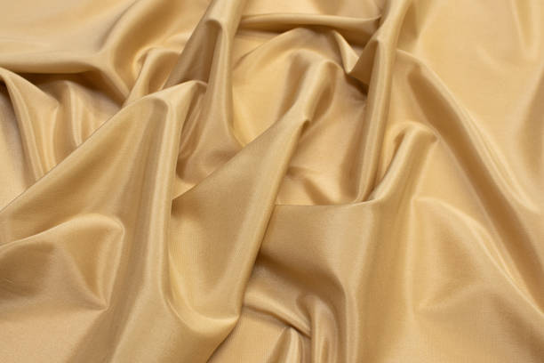 istock The texture of the synthetic fabric is light brown. Background, pattern. 1165519683