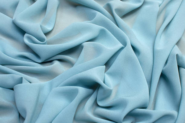 The texture of the silk fabric is gray-blue. Background, pattern, chiffon. The texture of the silk fabric is gray-blue. Background, pattern, chiffon. viscose stock pictures, royalty-free photos & images