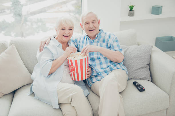 istock Above high angle view of two nice attractive cheerful cheery positive spouses having fun spending free time watching serial funny cinema in light white interior living-room indoors 1165520460