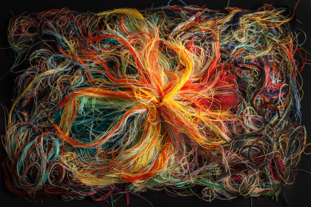 istock Colorful tangled threads on black background. Closeup. 1165521188