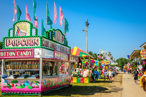 Falmouth, Massachusetts, USA-July 26, 2019-   Food trucks, games of chance and carnival  rides attract people of all ages to  the Barnstable County Fair held each summer at the fairgrounds in Falmouth, Massachusetts.