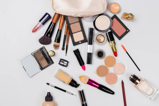 istock Makeup products with cosmetic bag and macaroons on light background 1165521388