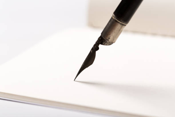 istock diary with fountain pen on white close-up 1165521514