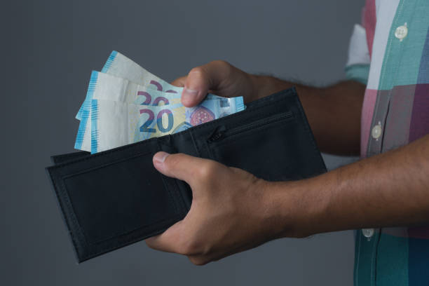 istock hand holding money in the wallet 1165521837