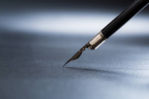 istock Old fountain pen on a black textured background 1165522852