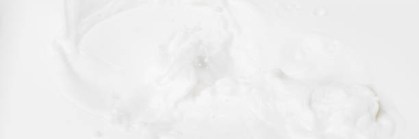 istock White abstract liquid background for cosmetics. Cream white background texture for web banner. Natural milk abstract blurred web banner for beauty. 1165525513