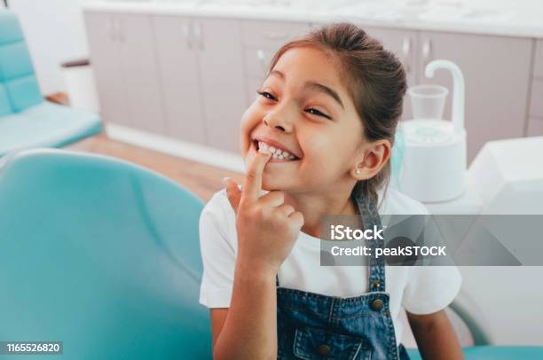 Mixed Race Little Patient Showing Her Perfect Toothy Smile While Sitting Dentists Chair Stock Photo - Download Image Now