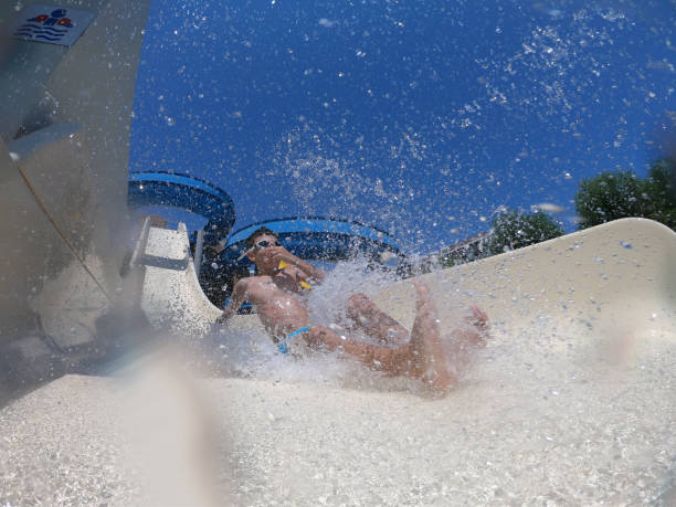 istock Happy boy sliding at water park 1165527028