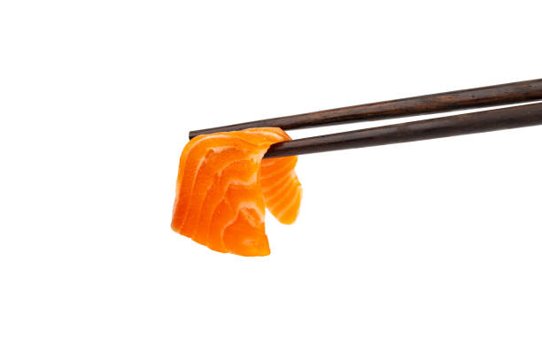 istock Salmon raw sashimi with chopsticks on a white background 1165527801