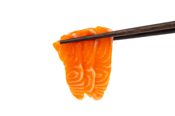 istock Salmon raw sashimi with chopsticks on a white background 1165527831