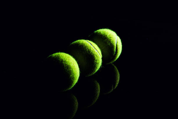 istock Tennis Ball isolated on black with dramatic lighting 1165527889
