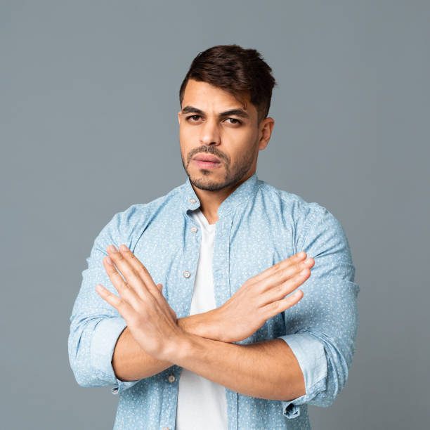 istock Serious Arab Man Gesturing Stop Sign With Crossed Hands 1165528011