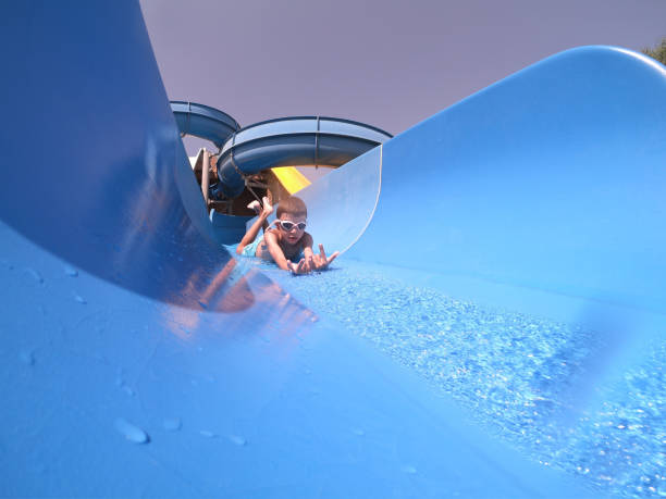Happy boy sliding at water park