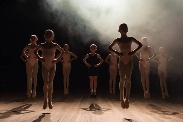 istock happy children doing ballet jump 1165528327