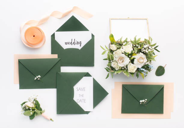 istock Stylish green envelopes with save the date text and accessories 1165528400