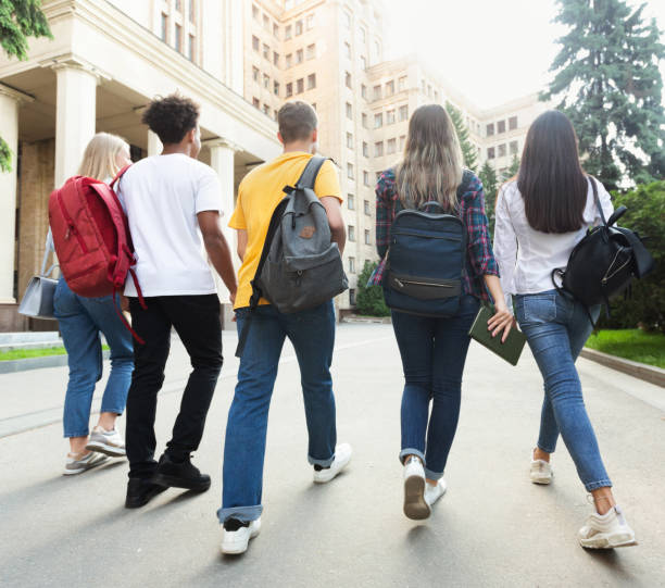 Group of students walking together in campus after studies Group of students walking together in campus after studies, having break multi ethnic group college student group of people global communications stock pictures, royalty-free photos & images