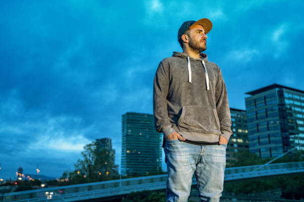 istock Young man with the Barcelona skyline at background 1165534716