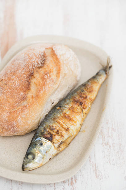 istock grilled sardine with bread on dish 1165536375