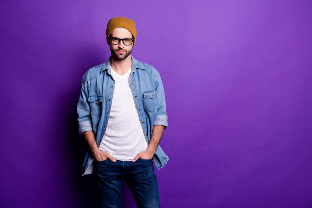 istock Portrait of his he nice attractive modern content bearded guy holding hands in pockets isolated over bright vivid shine violet lilac purple background 1165538079