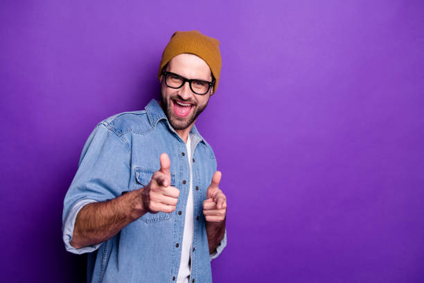 istock Portrait of his he nice attractive confident content cool cheerful cheery glad bearded guy pointing two forefingers at you flirting isolated over bright vivid shine violet lilac background 1165538191