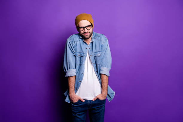 istock Portrait of his he nice attractive discontent bearded guy holding hands in pockets avoiding ignoring participation isolated over bright vivid shine violet lilac purple background 1165538381